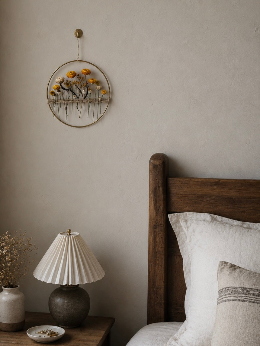 Everlasting daisy wall hoop displayed in a bedroom — dried flower wall art in a home setting