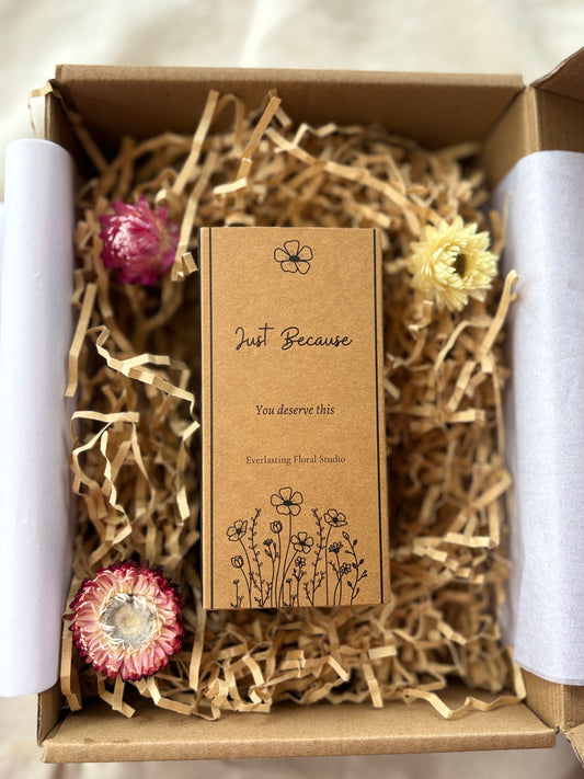 Box with decorative flowers and a card inside