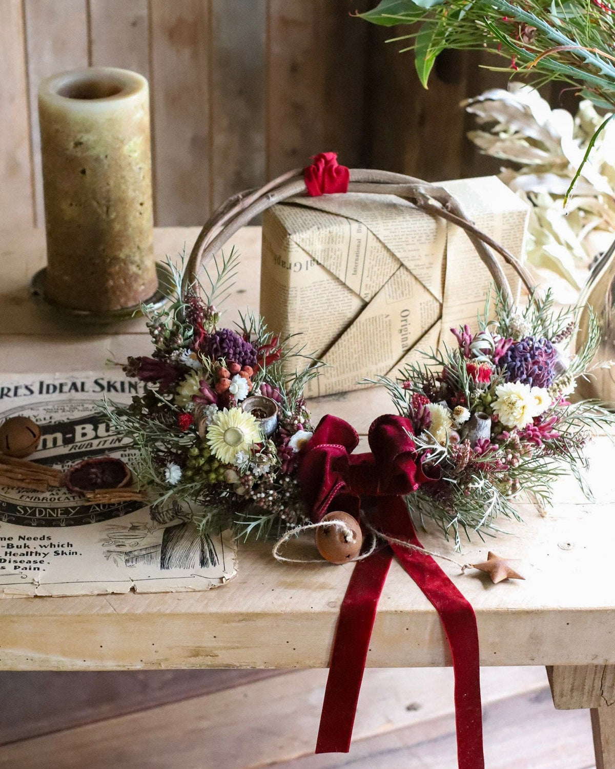 Waratah Christmas wreath of dried Australian native flowers on a woven vine base with a red velvet bow